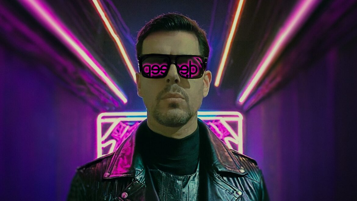 Portrait of Costa Mee wearing sunglasses with neon lights reflecting the Deep Disco Records logo.